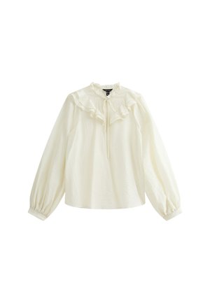 Blusa blanca de manga larga con cuello y puños con volantes, que presenta un detalle de lazo en la parte del cuello. Confeccionada en una tela ligera con un acabado texturizado.