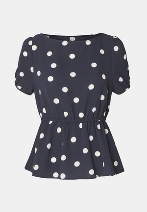 Mornarsko modra bluzica z belimi pikami, kratkimi napihnjenimi rokavi, okroglo ovratnikom in z zbranjem v pasu, kar ustvarja peplum učinek. Mehka tekstura tkanine.