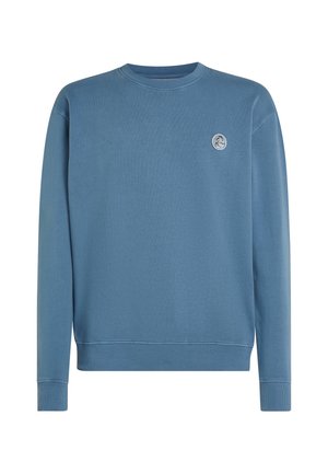 Crewneck sweatshirt i blekt blått, tillverkad av bomull, med en liten rund logotyp på bröstet. Långa ärmar med ribbade mudd och fåll.