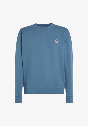 Mėlynas, išblukęs jeito megztinis su apvalia iškirpte, pagamintas iš medvilnės, su mažu apvaliu logotipu ant krūtinės. Ilgos rankovės su gumuotais rankogaliais ir apatine dalimi.