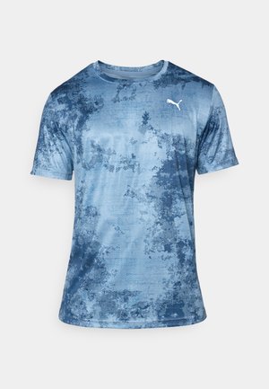 Blue athletic t-shirt with a textured, abstract pattern. Short sleeves, crew neck, and a white Puma logo on the chest. Lightweight material.