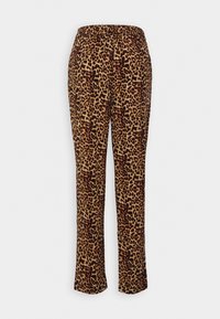 Pantalon droit avec motif léopard marron et noir et taille élastique sur fond uni.