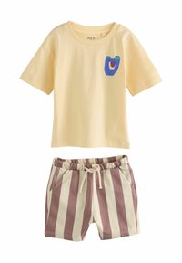 Yellow cotton T-shirt with a blue and green bear graphic, paired with beige and burgundy striped shorts with an elastic waistband and pockets.