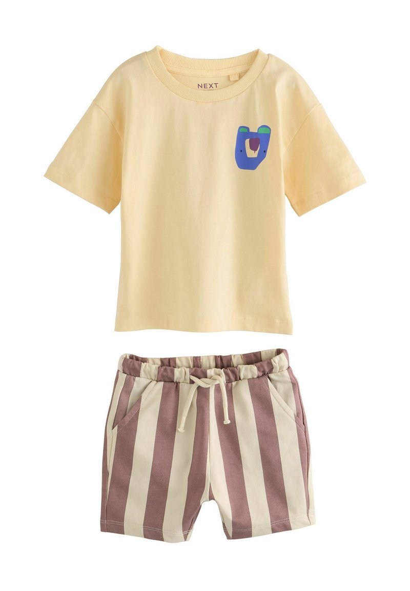 Yellow cotton T-shirt with a blue and green bear graphic, paired with beige and burgundy striped shorts with an elastic waistband and pockets.