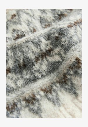 Tissu en laine tricoté dans des tons de gris clair, blanc et marron, présentant une texture douce avec un motif moucheté et des détails de couture visibles.