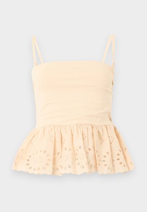 Haut sans manches beige avec fines bretelles, encolure droite, et ourlet en dentelle à œillets avec motif floral découpé.