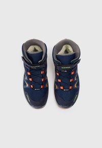 Par de botas de senderismo de invierno en Gore-Tex de color azul marino con lazos de encierre naranjas, correas de Velcro y forro de felpa acolchado, vistas desde arriba.