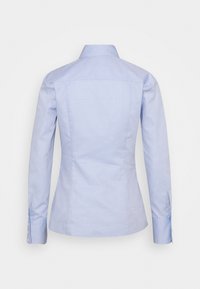 Camicia azzurro chiaro, design aderente, texture in cotone, maniche lunghe con polsini abbottonati e colletto classico. La vista posteriore mostra le cuciture sagomate.