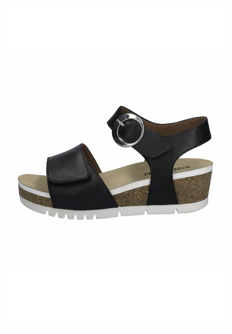 Schwarze Lederwedge-Sandale mit verstellbarem Riemen, kreisförmiger silberner Schnalle, Kork-Zwischensohle und weißer Gummi-Laufsohle. Glatte Innenauskleidung.