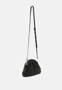 Black leather handbag with a rounded shape, pleated texture, zip closure, and an adjustable strap featuring gold-tone hardware accents.