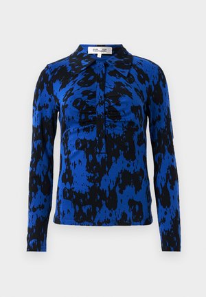 Long-sleeve shirt in a blue and black abstract pattern. Features a collared neckline and button closure with gathered detailing at the center.