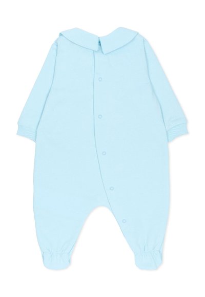 Tutina a maniche lunghe di colore azzurro chiaro con colletto, chiusure a scatto sul davanti e polsini elasticizzati per una vestibilità aderente. Materiale in morbido cotone.