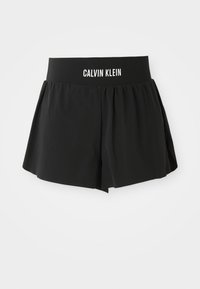 Pantaloni corti neri realizzati in tessuto morbido con una vita ampia ed elastica decorata con il marchio "CALVIN KLEIN". Design svasato con una texture liscia.