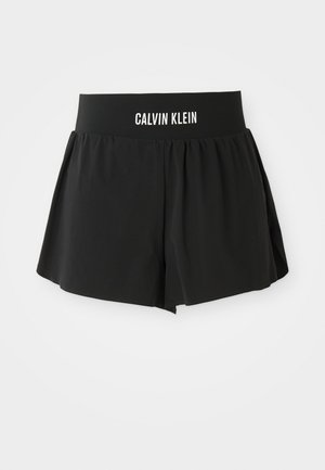 Zwarte shorts van zacht materiaal met een brede, elastische tailleband met "CALVIN KLEIN" merknaam. Uitlopende ontwerp met een soepele textuur.