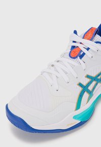 White athletic shoe with a textured upper, blue sole, orange and blue accents, and a geometric pattern on the side. Features laces for closure.