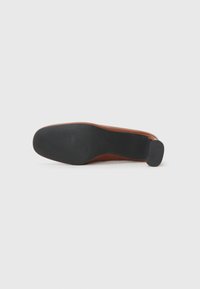 Brown leather shoe sole with a textured black rubber outsole, featuring a slight heel and smooth side contour.