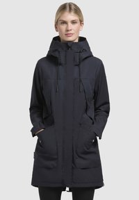 Navy parka jacket with a hood, front zip, two large side pockets, adjustable drawstrings, and a slightly longer back hem.