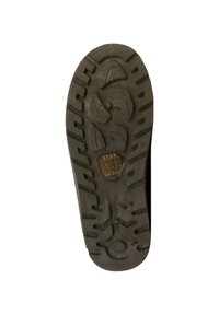 Semelle d'une chaussure, en caoutchouc noir, présentant des motifs de gomme profondes pour l'adhérence, avec des sections surélevées et un élément circulaire au talon.