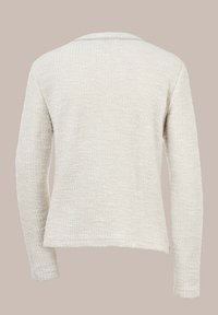 Hellbeige Pullover aus strukturiertem Stoff, mit langen Ärmeln und einem lässigen Schnitt sowie einem dezenten Saumdetail am unteren Ende.