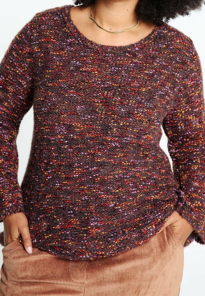 Texturerad, flerfärgad tröja med rund halsringning. Har nyanser av burgunder, lila, orange och inslag av klara färger. Långa ärmar.