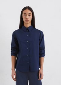 Navy blue button-up shirt with a structured collar and long sleeves, made of smooth fabric; features rolled sleeves and subtle buttons.