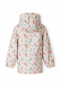 Impermeabile con uno sfondo color crema chiaro e motivi multicolori di unicorni e arcobaleni, maniche lunghe e cappuccio. Materiale liscio e impermeabile.