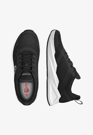 Schwarze Sportschuhe mit einem Obermaterial aus Mesh, Schnürdesign und weißer Zwischensohle. Merkmale sind strukturierte Akzente und ein Logo an der Seite.