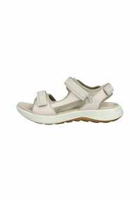 Sandal de color rosa claro con correas ajustables de Velcro, plantilla acolchada, diseño de punta abierta, entresuela blanca y suela de goma texturizada.