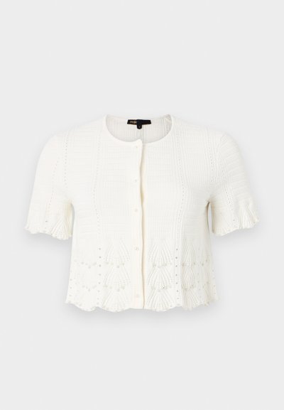 Vitt kortärmad cardigan med ett texturerat stickmönster, scallopkant och pärlprydnader längs den nedre kanten och ärmarna. Främre knappstängning.