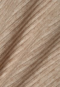 Beige ribbed fabric with a soft texture, featuring vertical lines and subtle variations in color. Ideal for clothing or upholstery.