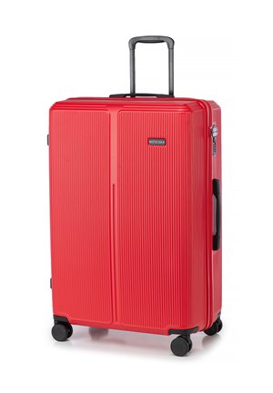 Red hard-shell suitcase with vertical ribbed texture, retractable handle, and four black wheels. Features a logo on front.