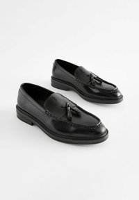 Sorte læder loafers med en glat overflade, prydet med slips og en syet design. Flade gummisåler giver stabilitet og komfort.