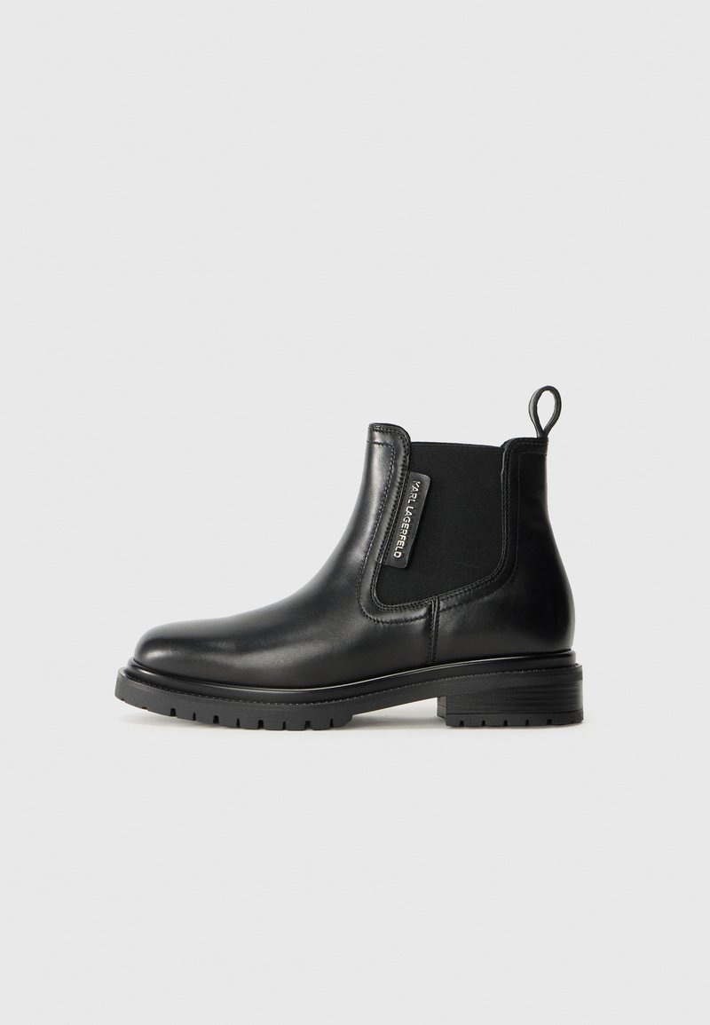 Black leather ankle boot with elastic side panels, rounded toe, pull tab at heel, and textured rubber sole. Simple design, smooth finish.