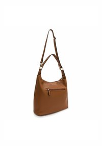 Brown leather shoulder bag with a smooth texture, a single shoulder strap, and a front zipper pocket. Rounded shape and minimal hardware.
