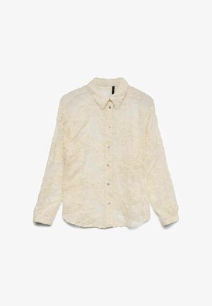 Chemise blanche avec broderie florale, boutons sur le devant et col. Comprend des manches longues et une texture légèrement transparente.