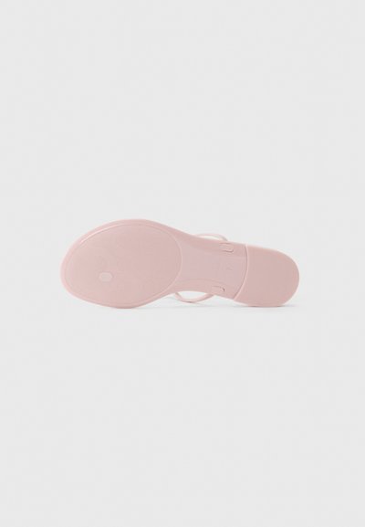 Semelle de sandale rose clair avec un motif texturé, comportant des rainures rondes et une sangle ajustable. Fabriquée en matériau flexible et durable.