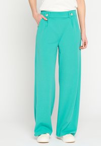 Turquoise wide-leg trousers made of soft fabric, featuring a flat front, two buttons at the waistband, and side pockets.