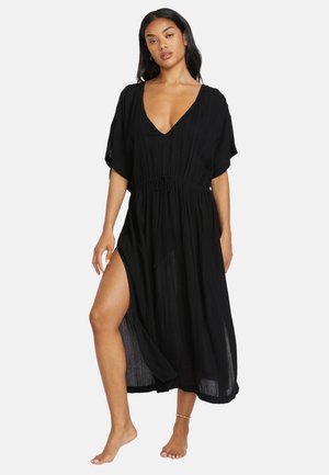Black maxi dress with a deep V-neck and short sleeves, featuring a drawstring waist and side slit. Made of lightweight, textured fabric.