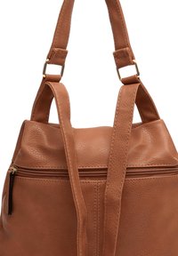 Tan leather shoulder bag with a textured finish, dual straps, and a zippered compartment. Features gold-tone hardware and stitched accents.