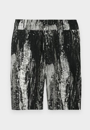 Calções com padrão a preto e branco, apresentando um design texturizado, cintura elástica e corte descontraído. Contrastes de cores notáveis e detalhes em salpicos.