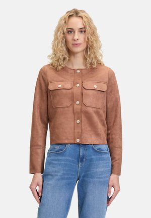 Brown suede cropped jacket with long sleeves, two front pockets, gold-tone buttons, and a rounded neckline. Worn over blue jeans.