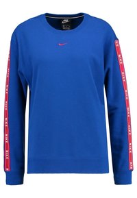 Blå sweatshirt med lång ärm, har röda Nike-logostripes längs ärmarna och en liten rosa Nike-logga på bröstet. Material i bomullsblandning.
