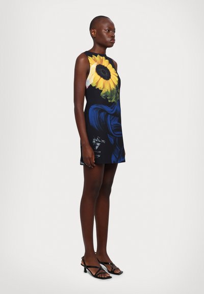 Sleeveless mini dress featuring a sunflower print on a navy background, with blue swirling patterns and side slits for added movement.