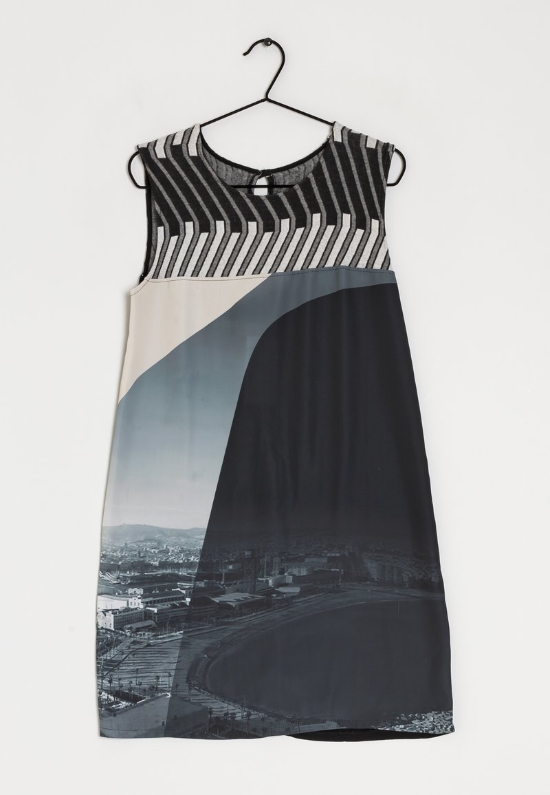 Sleeveless dress with a black and white striped bodice, transitioning to a multicolored bottom featuring a cityscape print. Smooth texture.