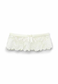 Spetsunderkläder med vågiga kanter, krämfärgad, elastiskt midjeband och en rosett i mitten. Mjuk textur med blommönster.
