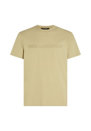 Vaalea beige lyhythihainen T-paita, jossa on pyöreä kaula-aukko ja kohotettu "KARL LAGERFELD" -logoteksti samaa sävyä rinnassa.