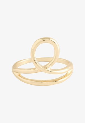 Gold-colored metal ring with a modern, abstract looped design on a white background.