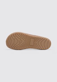Rubber shoe sole with a wavy pattern, light brown color, flat design, featuring a rectangular area for size marking.