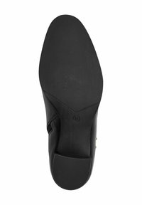 Suela de zapato de cuero negro con una superficie de goma texturizada, punta redondeada y un ligero tacón. Presenta el tamaño 37 en relieve en la suela.