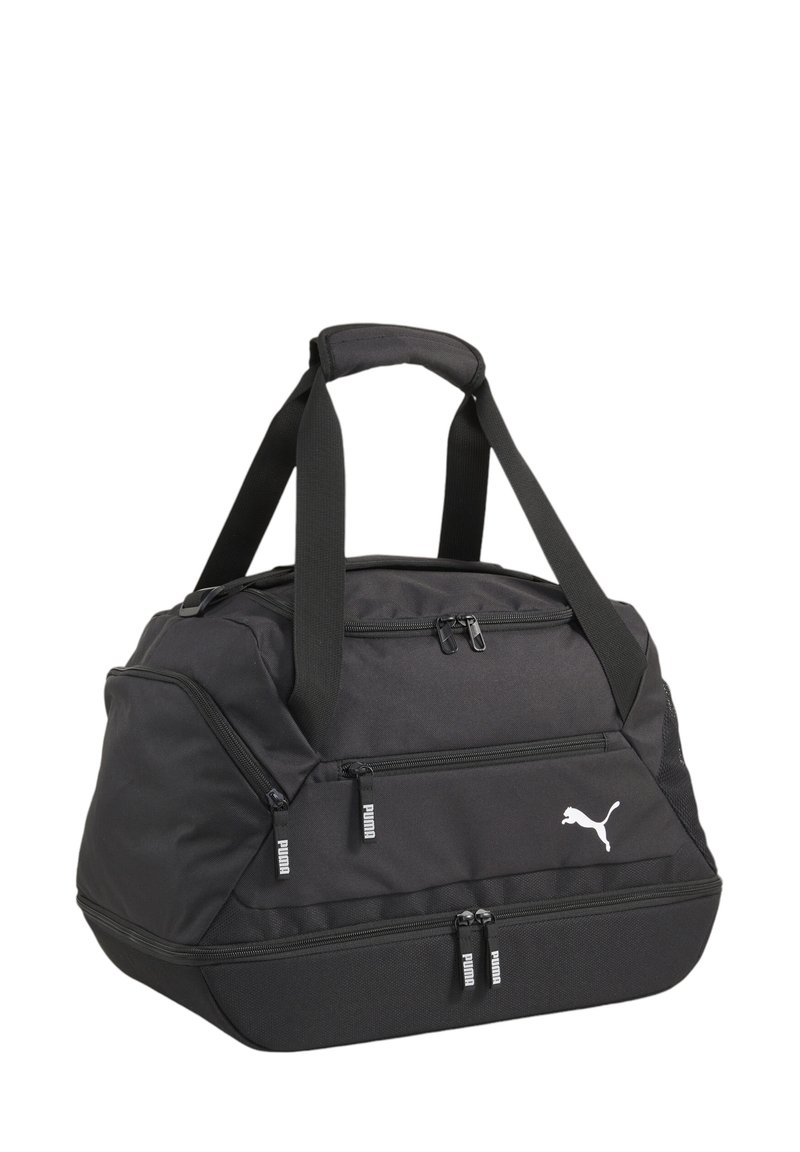 Black duffel bag made of durable fabric, featuring two zippered pockets, sturdy handles, and a white Puma logo. Spacious design with a textured finish.